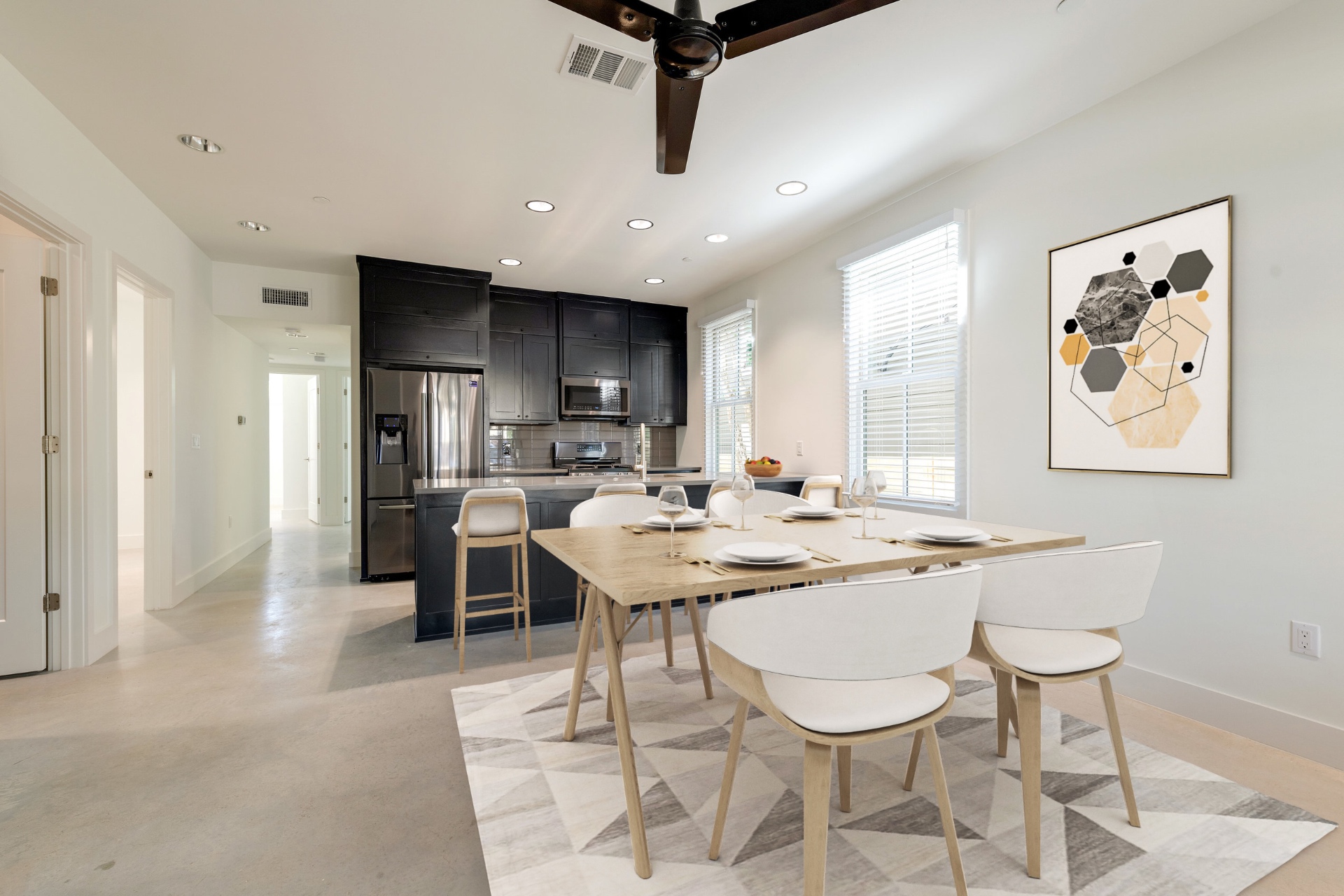 Unit 1-1 kitchen with dark cabinets and dining area